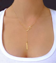 Vertical Bar Lariat Necklace  This sophisticated lariat necklace exudes luminous polish. Perfect for wearing alone or layering with other necklaces.  Vertical b Gold Long Drop Lariat Necklace Gift, Dainty Gold Lariat Necklace For Gift, Dainty Gold Lariat Necklace Gift, Adjustable Gold Lariat Necklace For Gift, Gold Dangle Lariat Necklace For Gift, Gold Dangle Lariat Necklace Gift, Adjustable Long Drop Lariat Necklace As Gift, Long Drop Adjustable Lariat Necklace As Gift, Adjustable Gold Lariat Necklace In Sterling Silver