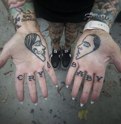 two people with tattoos on their hands are shown