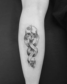 a black and white photo of a skull with a ribbon on it's leg