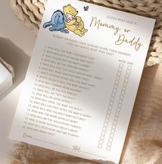 a winnie the pooh baby shower checklist next to a basket with a teddy bear on it