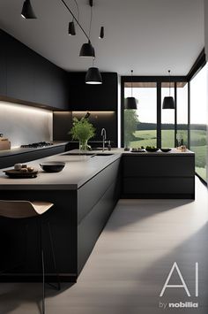 a modern kitchen with black cabinets and counter tops, along with an island in the middle