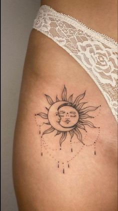 a woman's stomach with a sun and moon tattoo on it