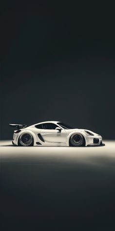 a white sports car is shown in the dark