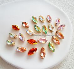 a white plate topped with lots of different colored stones