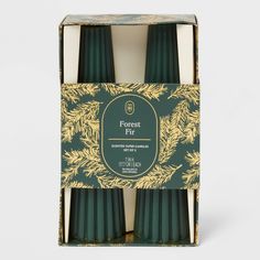 forest fair candles in a green box with gold pine branches on the front and bottom