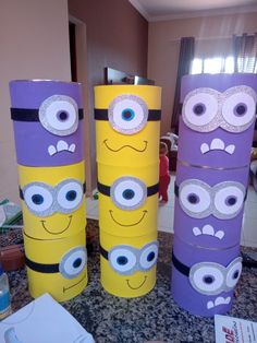 three cardboard cylinders decorated to look like minion faces