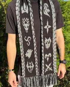 Picture of a Skyrim inspired scarf featuring images of the nine holds and two versions of the main logo. The scarf is black and grey and the back features a dragon design. Skyrim Crochet Pattern Free, Tapestry Crochet Scarf, Crochet Skyrim, Scarf Knit Pattern, Colorwork Chart, Cable Knitting Patterns, Scarf Knit, Sport Weight Yarn, Circular Knitting Needles