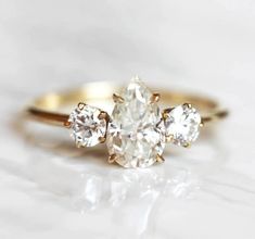 three stone diamond ring on white background