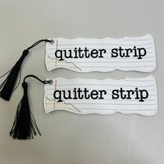 two bookmarks with tassels that read gutter strip and gutter strip