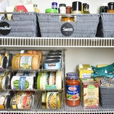 an organized pantry with food and condiments in baskets on the bottom shelf, along with other items