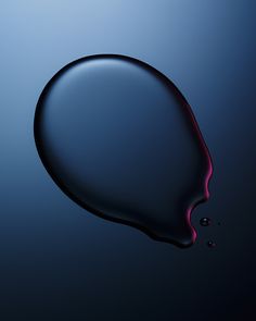 an image of a drop of liquid on a dark background with blue and red colors