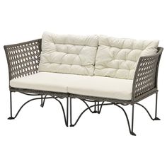 an outdoor sofa with white cushions