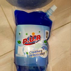 a bottle of pur clothes whitener sitting on top of a tiled countertop