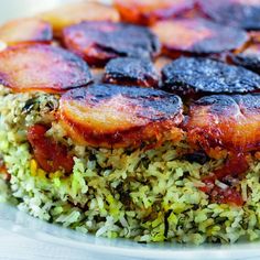 there is a plate with rice and meat on the top, as well as broccoli