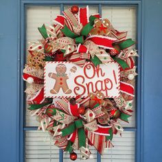 a christmas wreath with the words oh snap on it and a gingerbread man holding a candy cane