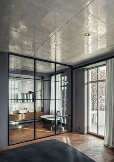 an empty bedroom with glass walls and sliding doors