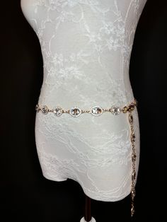 High quality metal chain & Jewel Stones on a gold metal base. Beautiful Jewels & Rhinestones on a gold metal base set off this belt.  Exclusively designed by FAN Design, this belt is made to a wide range of sizes. Matching necklace also available. Hand crafted to sizes.   Choose your waist size in inches, all belts will come with an extra 12 inch hanging chain Tap into the hottest new trend with chain belts! This chic piece of bodywear can be draped over your clothing to enhance your outfit or worn with bare midriff looks. Pair it with a simple black ensemble for an elegant finish. Perfect accessory for a wide range of outfits. Elegant Metal Waist Chain Belt, Gold-tone Adjustable Chain Belt For Party, Luxury Gold-tone Elegant Chain Belt, Luxury Elegant Chain Belt With Gold-tone Hardware, Luxury Gold-tone Metal Chain Belt, Chain Belts, Rhinestone Belt, Suspender Belt, Matching Necklaces