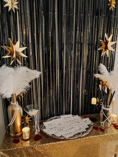 a table topped with a cake covered in white frosting and gold stars on top of it