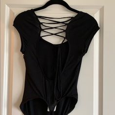 Criss Cross Detail On Back Never Worn Open Back Scoop Neck New With Tags Sleeveless Stretch Bodysuit With Tie Back, Fitted Black Bodysuit With Tie Back, Black Backless Bodysuit With Tie Back, Free People Bodysuit, Puff Sleeve Shirt, Ruffle Tank Top, Free People Tunic, Pink Bodysuit, Casual Long Sleeve Shirts