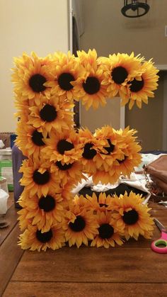 the letters are made out of sunflowers