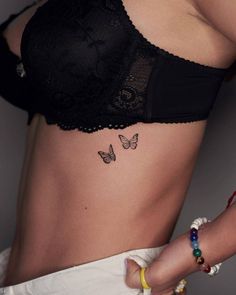 a woman with a butterfly tattoo on her stomach