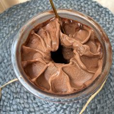 a chocolate dessert in a glass with a straw sticking out of it's side