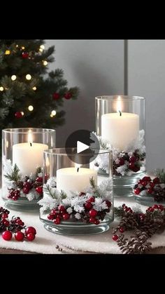 candles are sitting on a table with christmas decorations