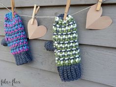 three mittens hanging from clothes line with paper hearts attached to the clothes pegs