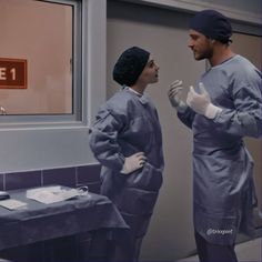 two doctors in scrubs talking to each other