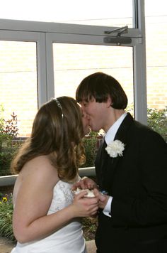 a bride and groom are sharing a kiss