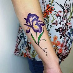 a woman with a purple flower tattoo on her arm