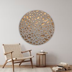 a living room with a chair and a large metal wall art piece on the wall