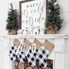 christmas stockings hanging from a mantel in front of a fireplace