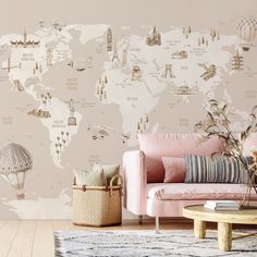 a living room with a pink couch and map wallpaper