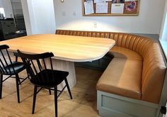 a kitchen table with two chairs and a bench in front of the counter top area