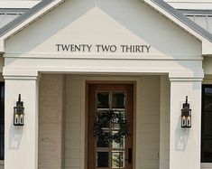 the front entrance to twenty two thirty is decorated with wreaths and hanging lantern lights