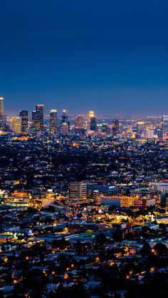 an aerial view of the city lights and skyscrapers at night in los angeles, california