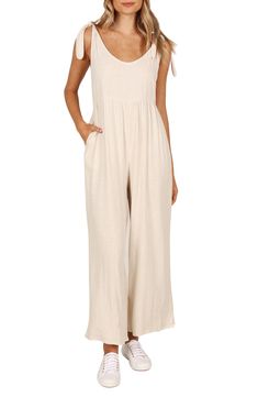 Elevate your contemporary wardrobe with this tie-shoulder linen jumpsuit finished with wide legs and handy side pockets. Pull-on style Adjustable tie straps Side-seam pockets Unlined 100% linen Hand wash, dry flat Imported Beige Linen Casual Jumpsuits And Rompers, Chic Beige Linen Jumpsuits And Rompers, Linen Jumpsuit For The Beach, Linen Jumpsuits And Rompers For Summer, Solid Color Linen Jumpsuits And Rompers For Summer, Summer Linen Jumpsuits And Rompers With Adjustable Straps, Beige Linen Jumpsuits And Rompers For Loungewear, Beach Linen Wide Leg Jumpsuits And Rompers, Linen Wide Leg Jumpsuits For Beach