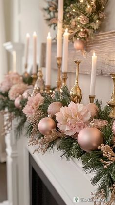 christmas garland with pink flowers and gold candlesticks on the mantel in front of a fireplace