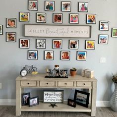 a wall with many pictures on it and a table in front of it that says collect beautiful moments