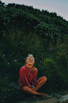 a woman sitting on the ground with her eyes closed