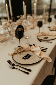 the table is set with black and white place settings