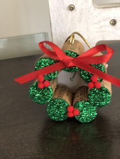 an ornament made out of wine corks with red ribbon