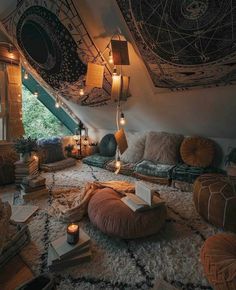 a room with lots of pillows and lights on the ceiling