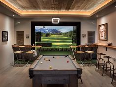 a pool table and television in a room