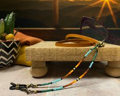 "You'll think of a western sunset when you see the colors in this minimalist beaded leather eyeglass chain.  These very tiny seed beads add just enough color without being bulky or gaudy.  Measures 27\" from end to end.  Need a different length? Request the length you prefer in the note to seller when you check out.  * Theres a photo to help determine the perfect length for you.  Details: * Tiny glass seed beads * Silver or brass plated hardware that is lead and nickel free * Silicone grips asse Handmade Adjustable Brown Glasses Chains, Brown Handmade Adjustable Glasses Chains, Adjustable Handmade Brown Glasses Chains, Handmade Brown Glasses Chains, Bohemian Adjustable Glasses Chains For Everyday Use, Eye Glasses Holder, Western Sunset, Glasses Chains, Glasses Holder