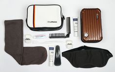 an assortment of grooming items laid out on a white surface, including a case