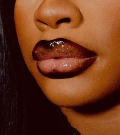 a close up shot of a woman's lips with glitter on her lip and nose ring