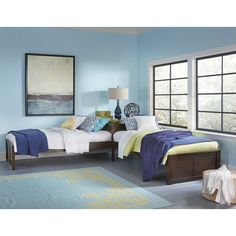 two beds in a room with blue walls