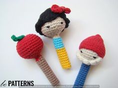 three crocheted items are sitting on a white surface, one has a red apple and the other is a blue toothbrush